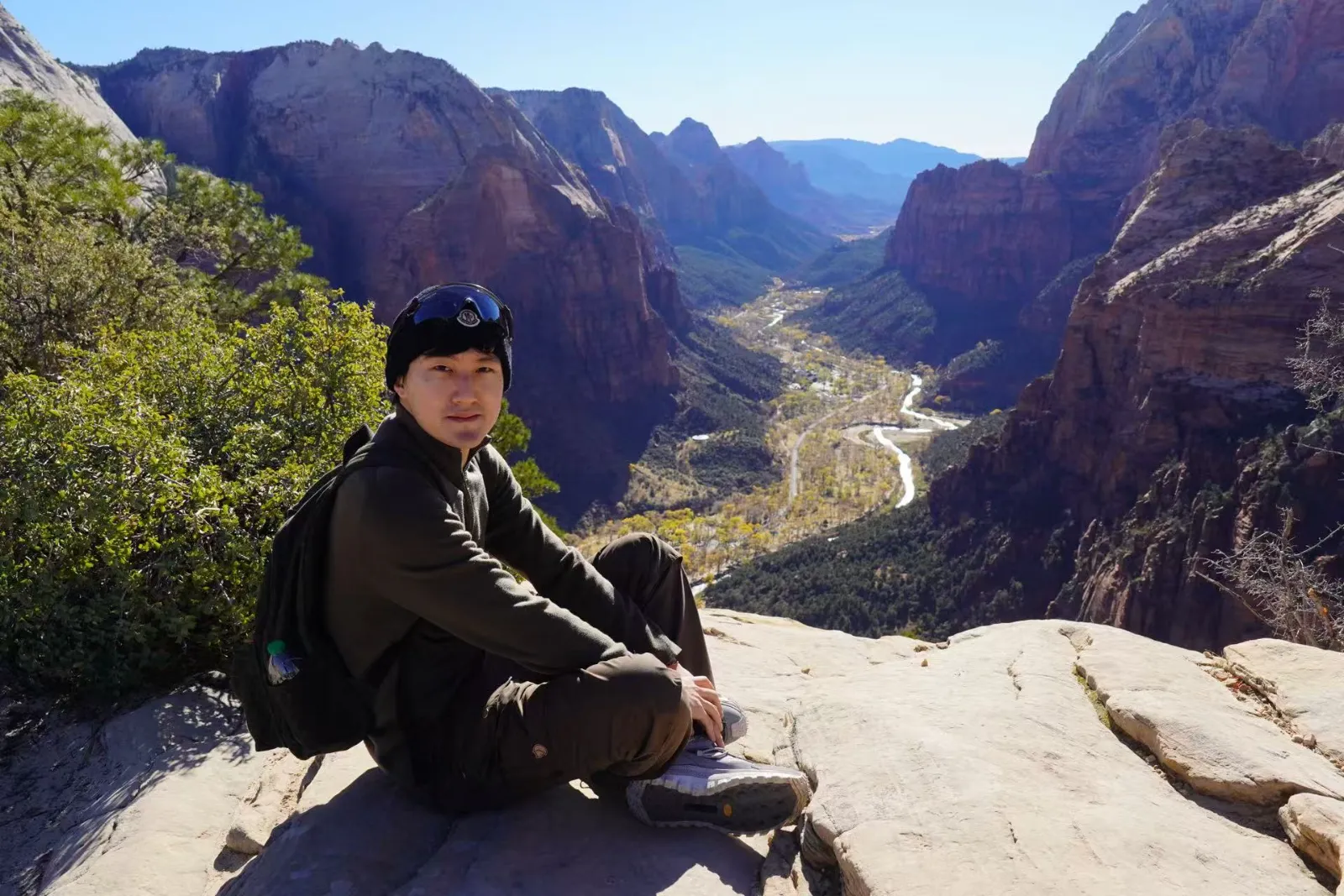 Sitting on the canyon rim above the valley at Zion